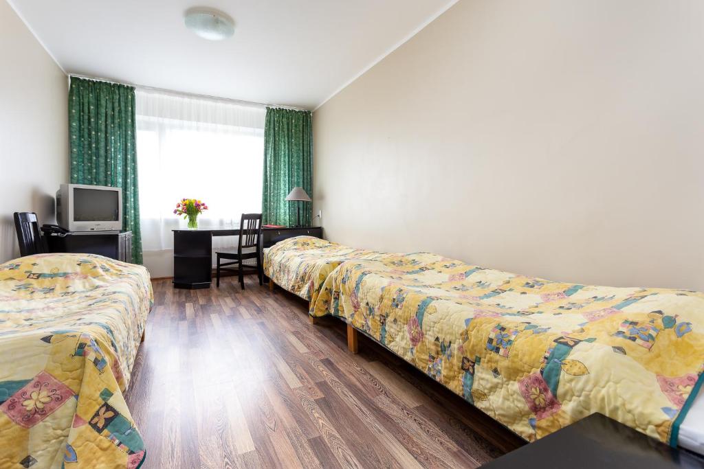 Postel nebo postele na pokoji v ubytování Hotel Dzingel