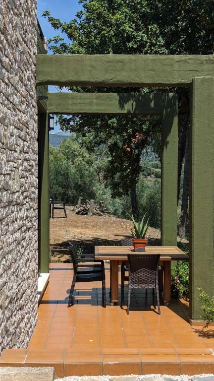 a patio with a wooden table and two chairs at Villa Khaki 