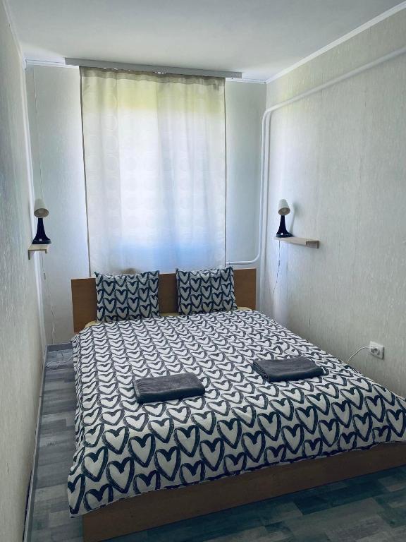 a bedroom with a bed with two pillows on it at Füred Apartman in Balatonfüred