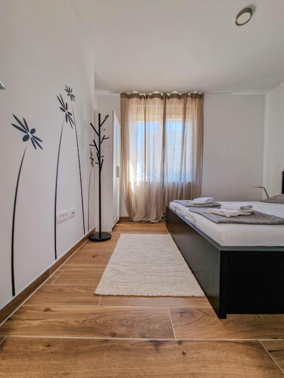 sypialnia z łóżkiem i oknem w obiekcie Villa Miss Sunshine with private jacuzzi w Novalji