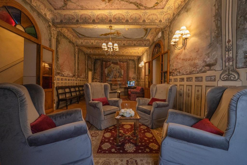 a living room with chairs and a table at Hotel Palazzo San Niccolò & Spa in Radda in Chianti