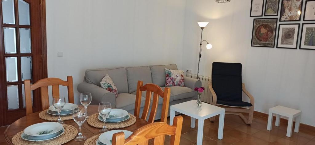 a living room with a table and a couch at Puerta del Sol - Plasencia in Plasencia