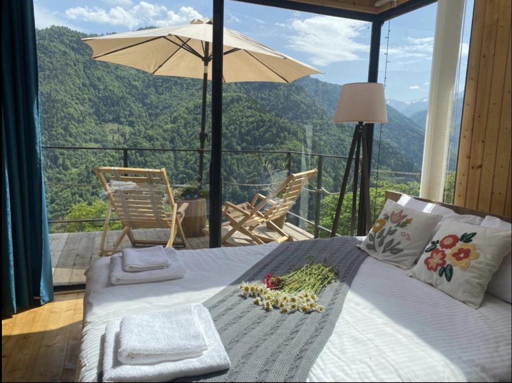 a bedroom with a bed with a view of a mountain at House in mountains, near Batumi- Lemanor Lodge in Kʼveda Chʼkhutunetʼi