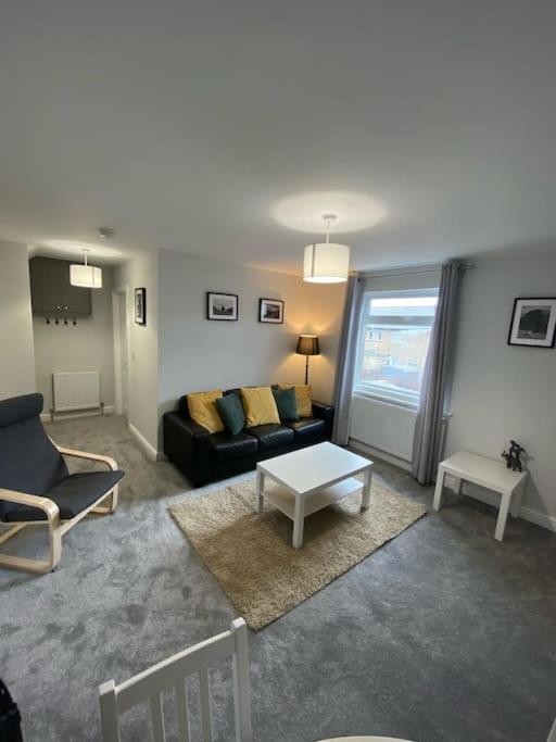 a living room with a couch and a table at Storey Apartment in Woodhorn