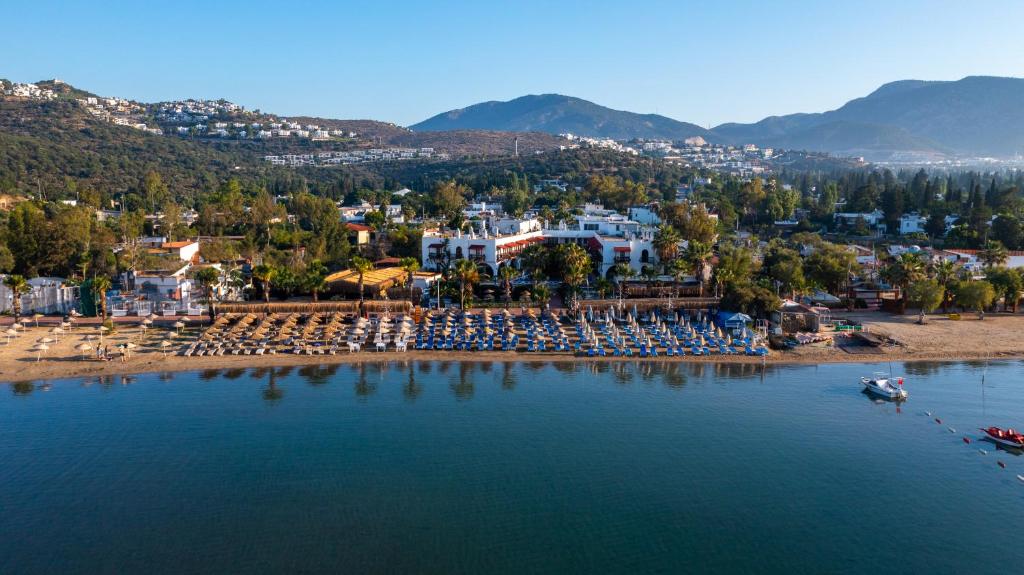 uma vista aérea de uma praia com cadeiras e um resort em Costa Bitezhan Hotel - All Inclusive em Bitez