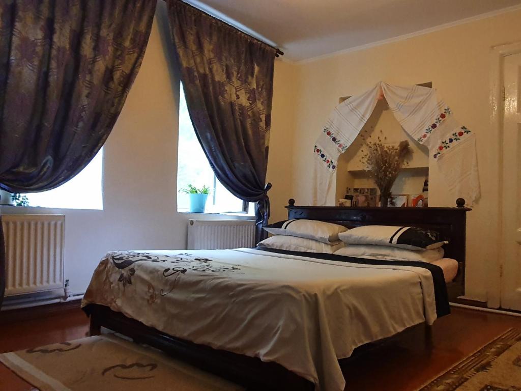 a bedroom with a bed and a large window at Authentic apartment in the centre in Chişinău