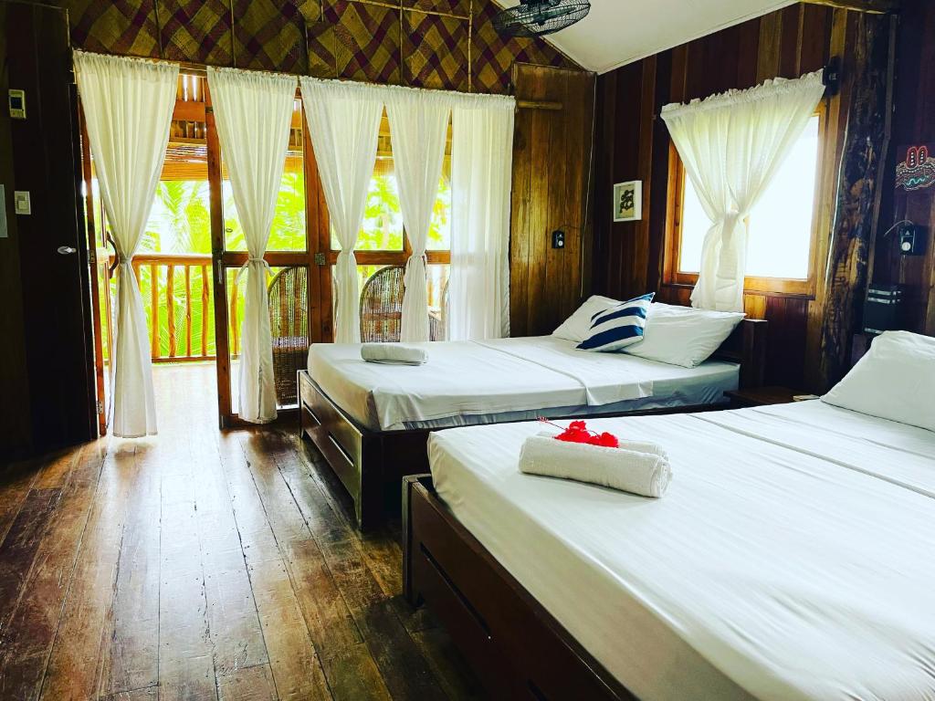 Voodi või voodid majutusasutuse White Beach Front and Cottages toas