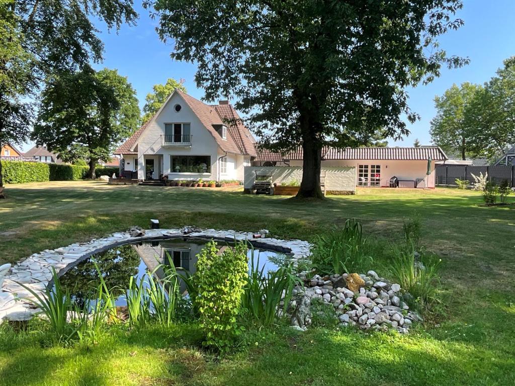 un étang dans la cour d'une maison dans l'établissement Kleine Villa Marleen, Ferienwohnung, à Schneverdingen