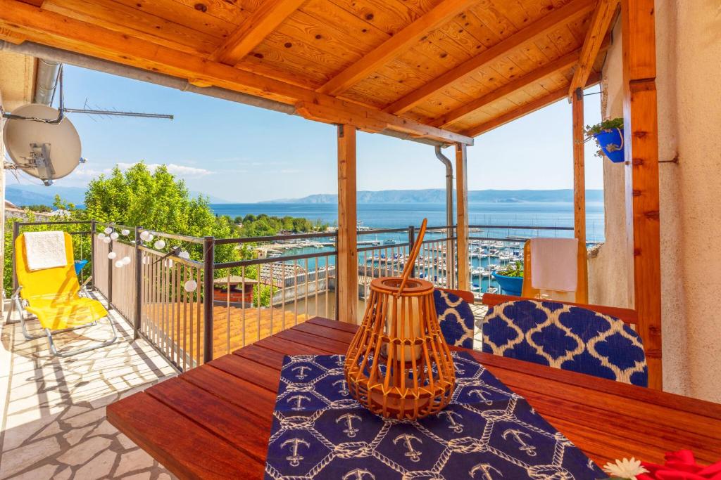 a table on a balcony with a view of the ocean at Mudrovcic in Novi Vinodolski