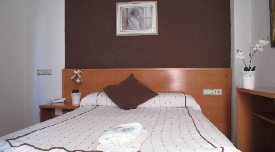 Postel nebo postele na pokoji v ubytování Hotel New Sanz