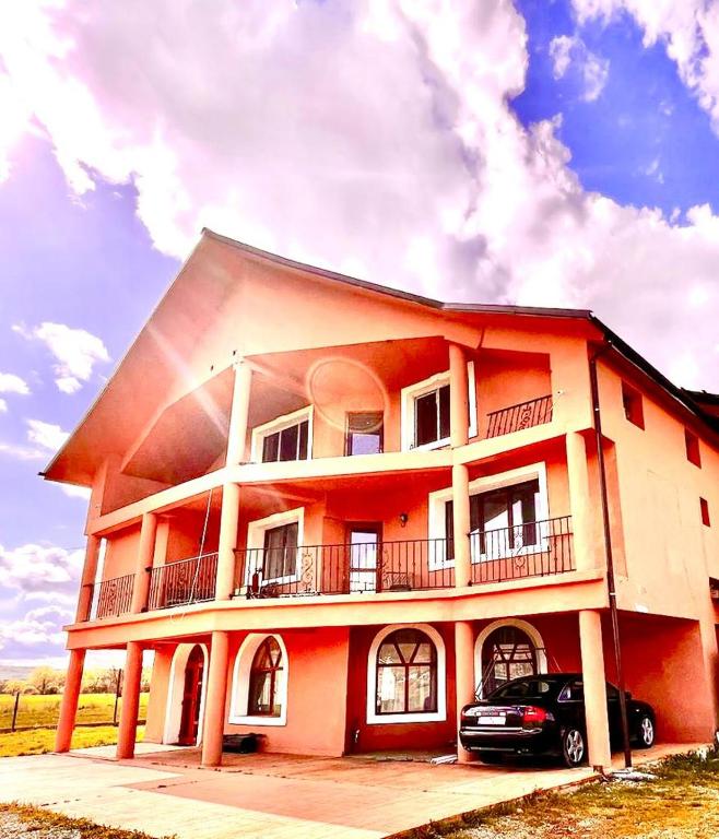 a building with a car parked in front of it at Casa Mardar in Oradea