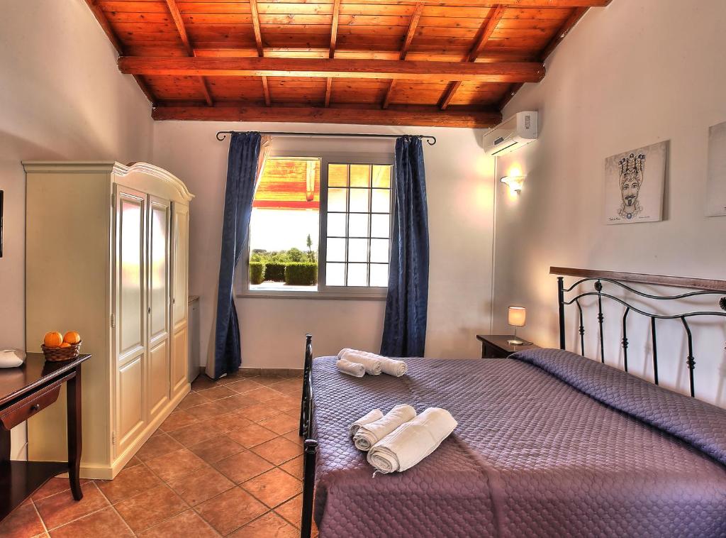 Postel nebo postele na pokoji v ubytování B&B Il Mandorleto Avola