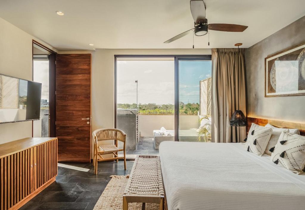 a hotel room with a bed and a tv at Divine 1BR PH with Private Pool and Spectacular Pools in Tulum