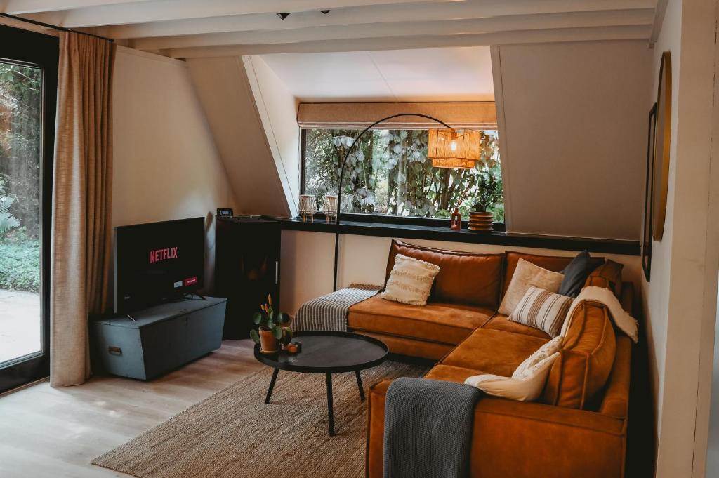 ein Wohnzimmer mit einem Sofa und einem Tisch in der Unterkunft Boshuisje Rekem - Topo in Lanaken