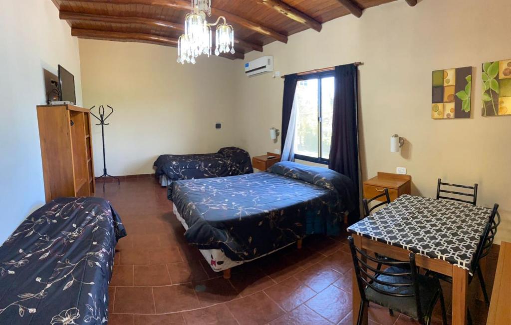 a living room with two beds and a table at Apart hotel la soñada in Federación