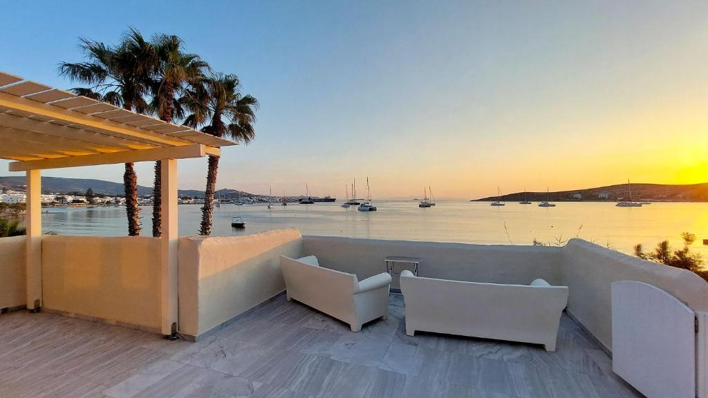 a patio with chairs and a view of the water at Ricardo by the sea in Parikia