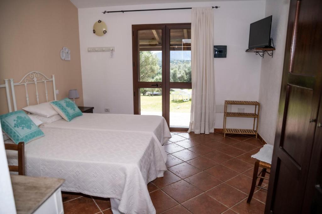 Postel nebo postele na pokoji v ubytování Agriturismo Sa Mendhula