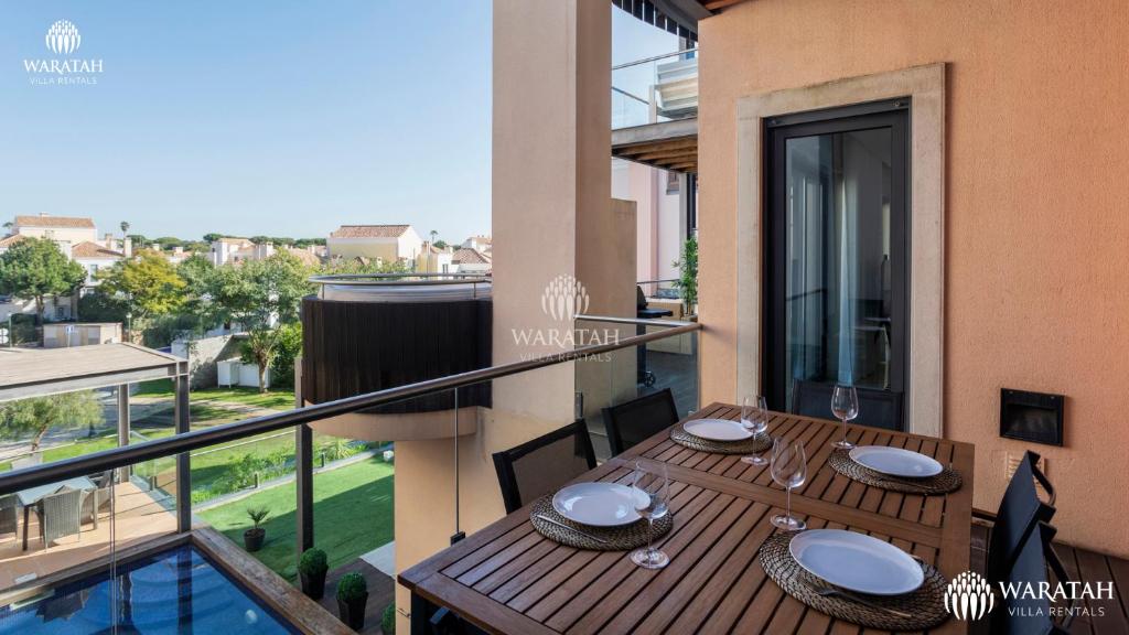 a dining table on a balcony with a view of the city at Apartment Micaela in Vale do Lobo