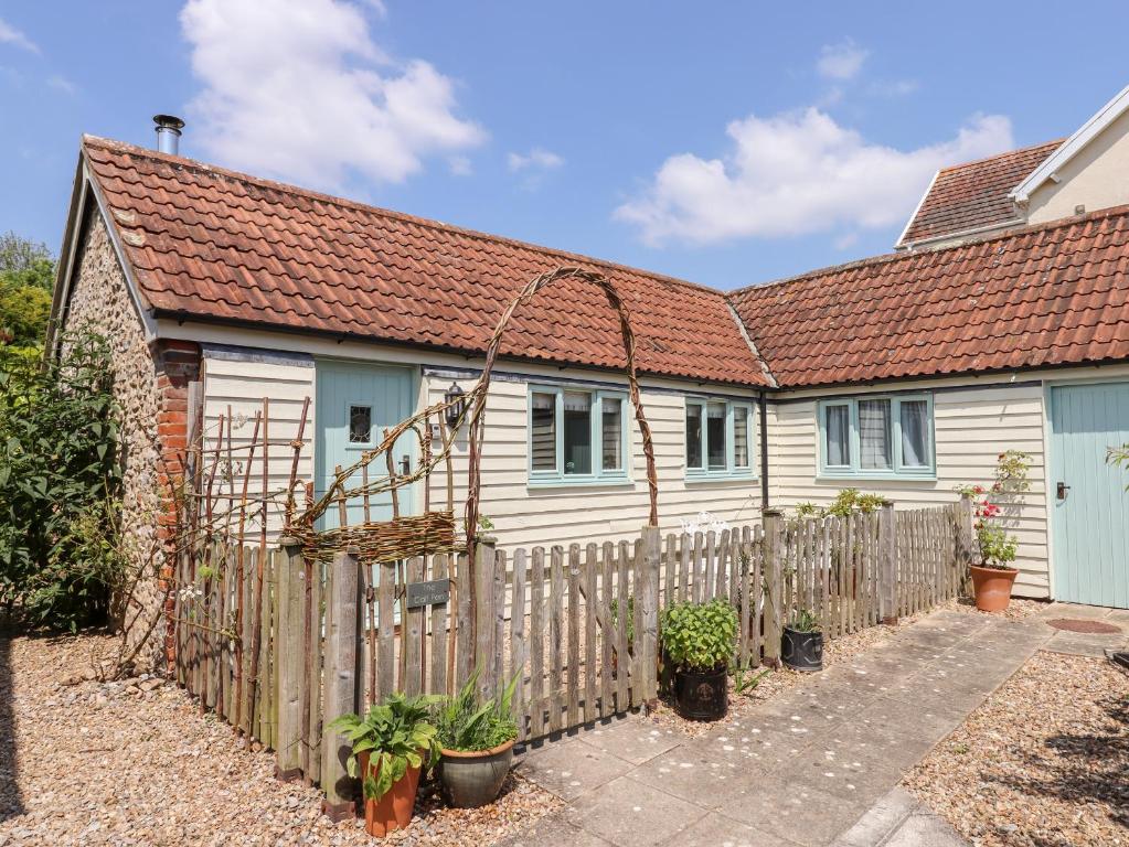 a house with a wooden fence in front of it at The Calf Pen in Colyton