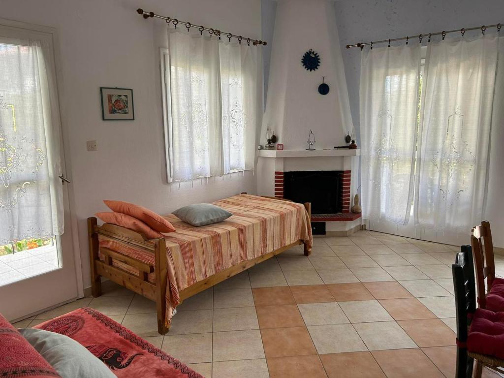 a bedroom with a bed and a fireplace at Orange Tree Garden in Pefkochori