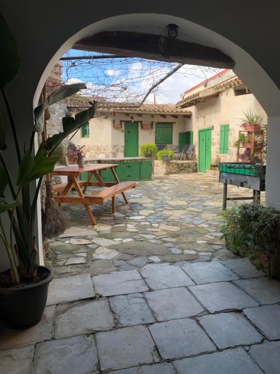 an outdoor patio with a table and a bench at To Spiti Sto Xorko in Lythrodontas