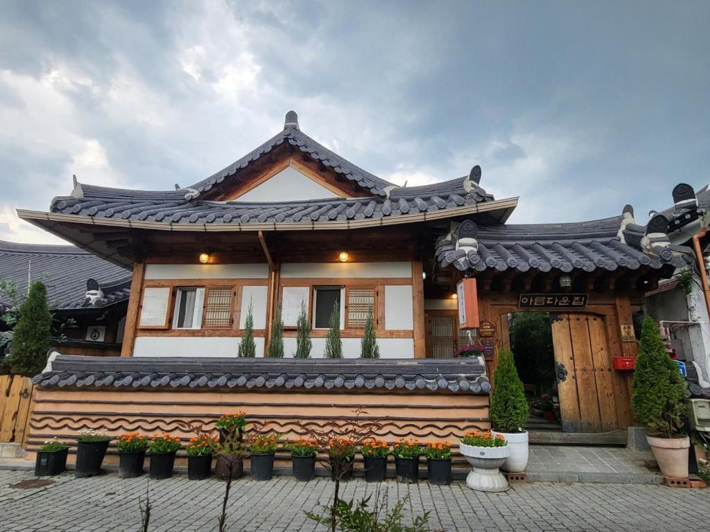 a house with a roof with plants in front of it at Beautiful House in Jeonju