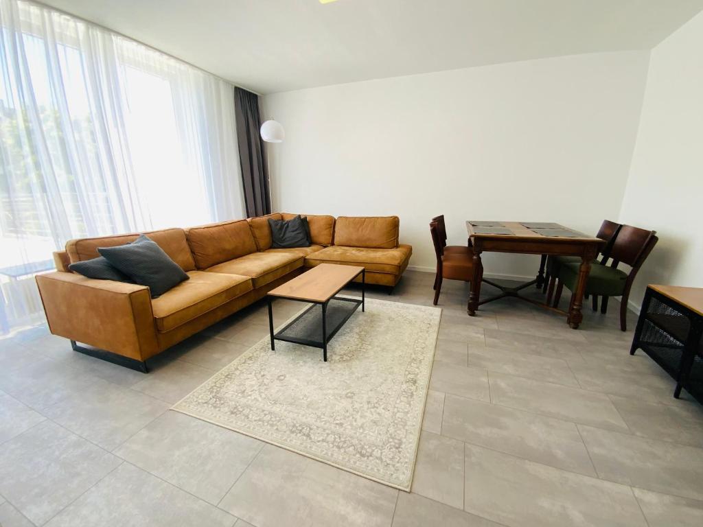 a living room with a couch and a table at Sehr schönes Haus mit Terasse nähe Düsseldorf in Krefeld