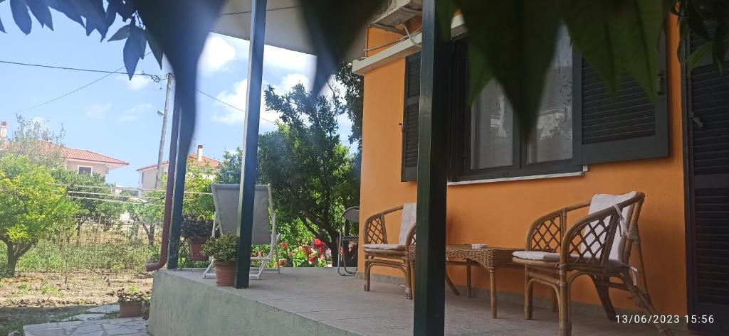 a patio with chairs and a table on a house at Orange Tree Garden in Pefkochori
