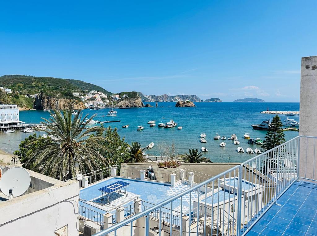 a balcony with a view of a body of water with boats at Casa delle rose - Immobilevante in Ponza