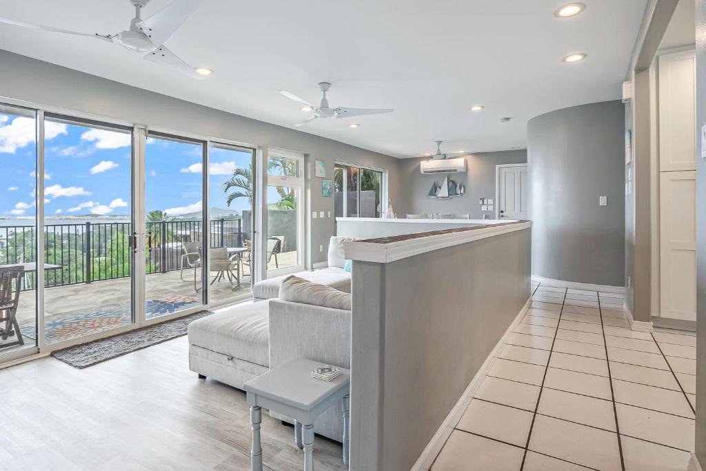 a kitchen and living room with a view of the ocean at Ka Hale me Ka ike 30 Night Minimum in Kaneohe