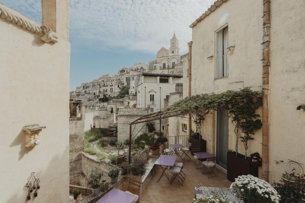 a view from an apartment balcony with tables and chairs at L'Arturo B&B in Matera