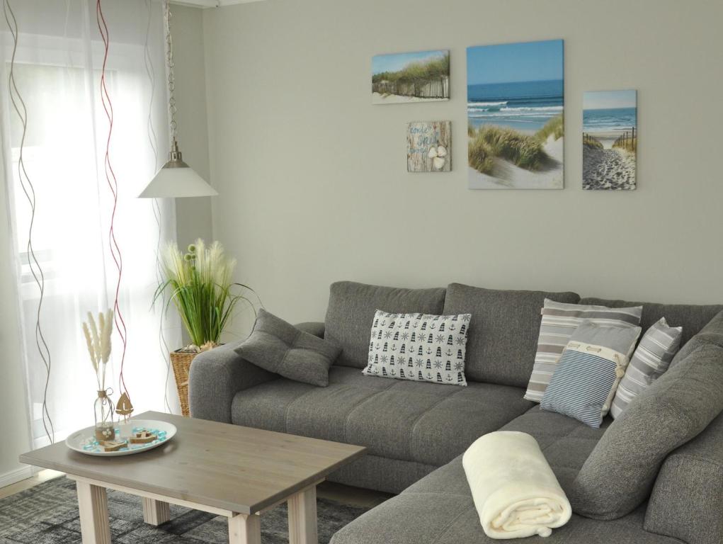 a living room with a gray couch and a table at Whg 09 - Fischerstuv in Zingst