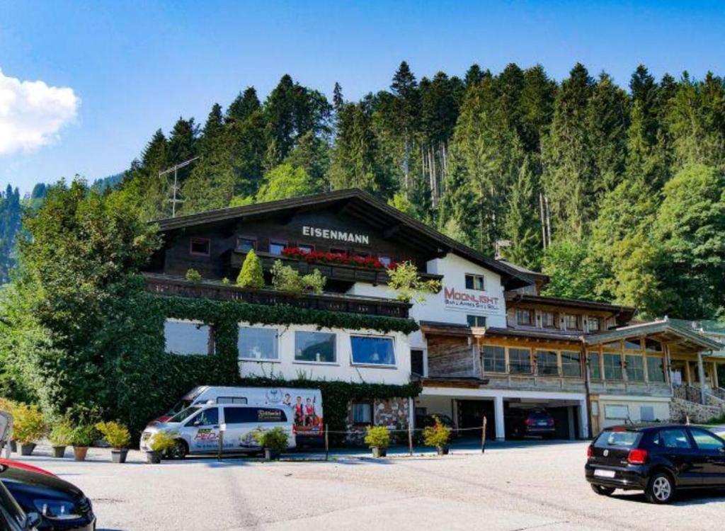 a large building with cars parked in front of it at Moonlight Appartements in Söll