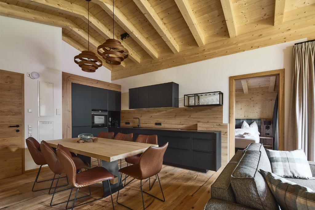 a dining room and kitchen with a table and chairs at Alm-Lodges Montafon in Gargellen