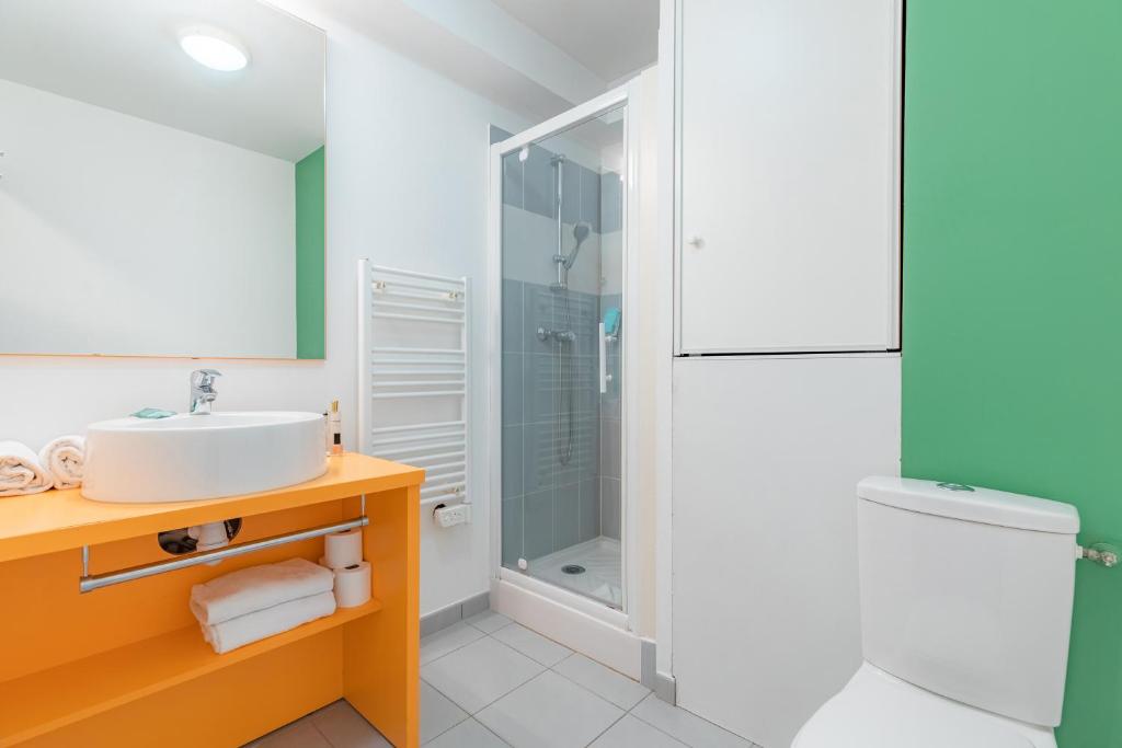 a bathroom with a sink and a shower at Appart’City Confort Tours in Tours