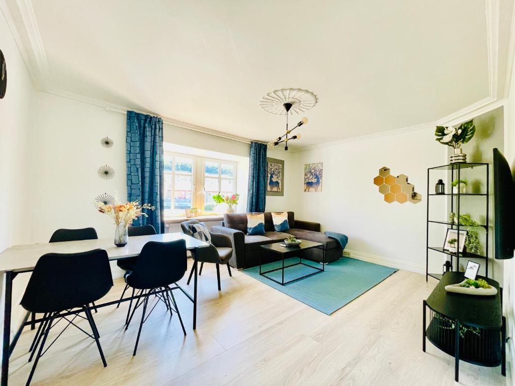 a living room with a table and a couch at aday - Modern 1 Bedroom Charming Central Apartment with Public Parking in Aalborg