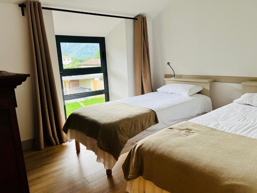 Posteľ alebo postele v izbe v ubytovaní Le Domaine d'Arignac - La grande maison