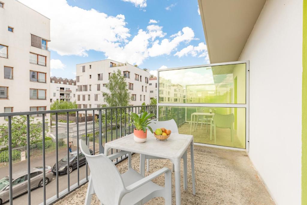 a balcony with a white table and chairs on it at Appart’City Confort Tours in Tours
