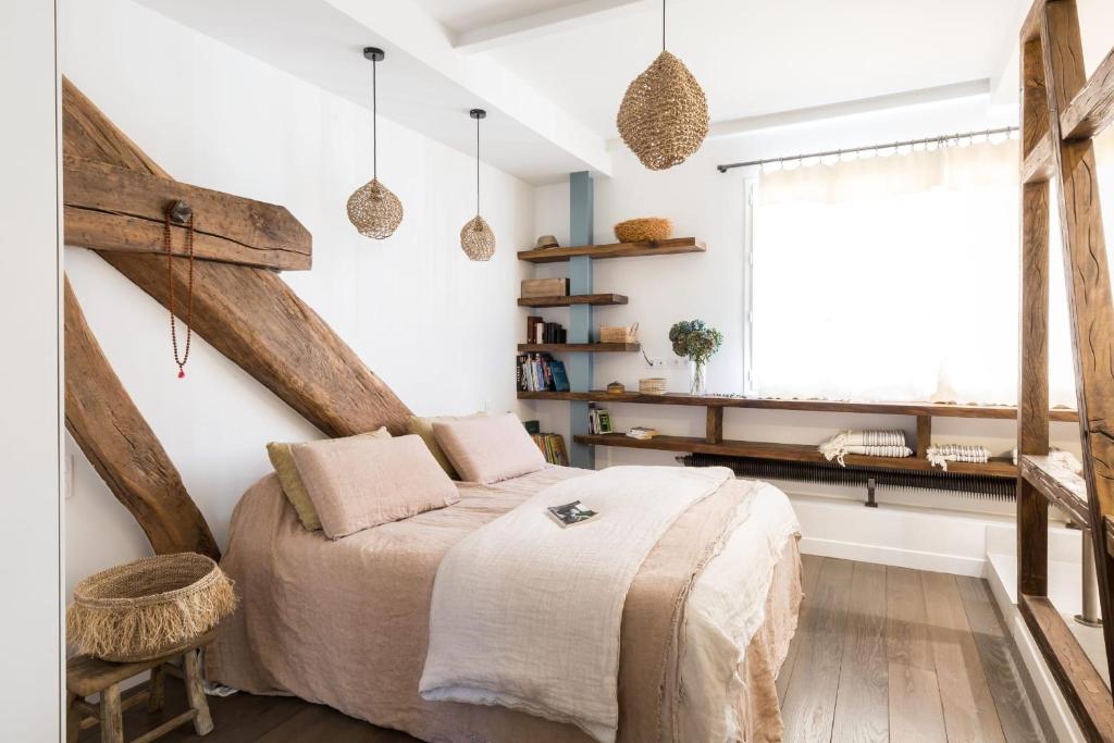 a bedroom with a large bed and a window at Beautiful loft in the 20th district of Paris - Welkeys in Paris