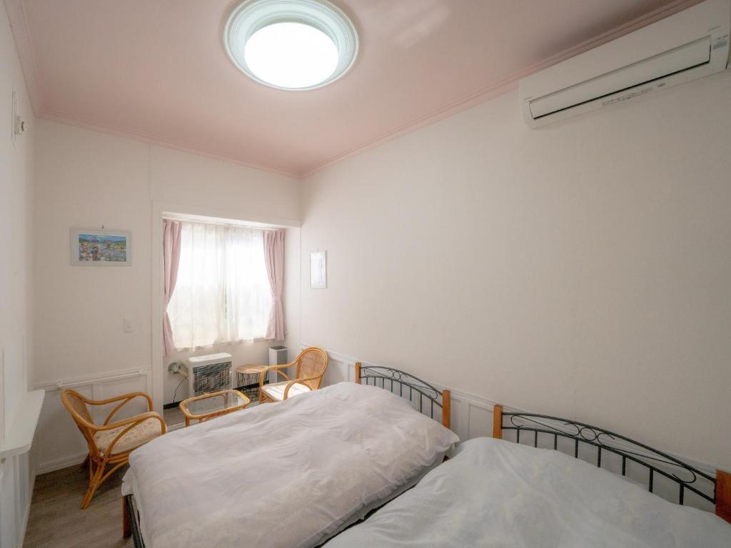 a bedroom with two beds and a window at Minpaku Ota - Vacation STAY 11959 in Otaru