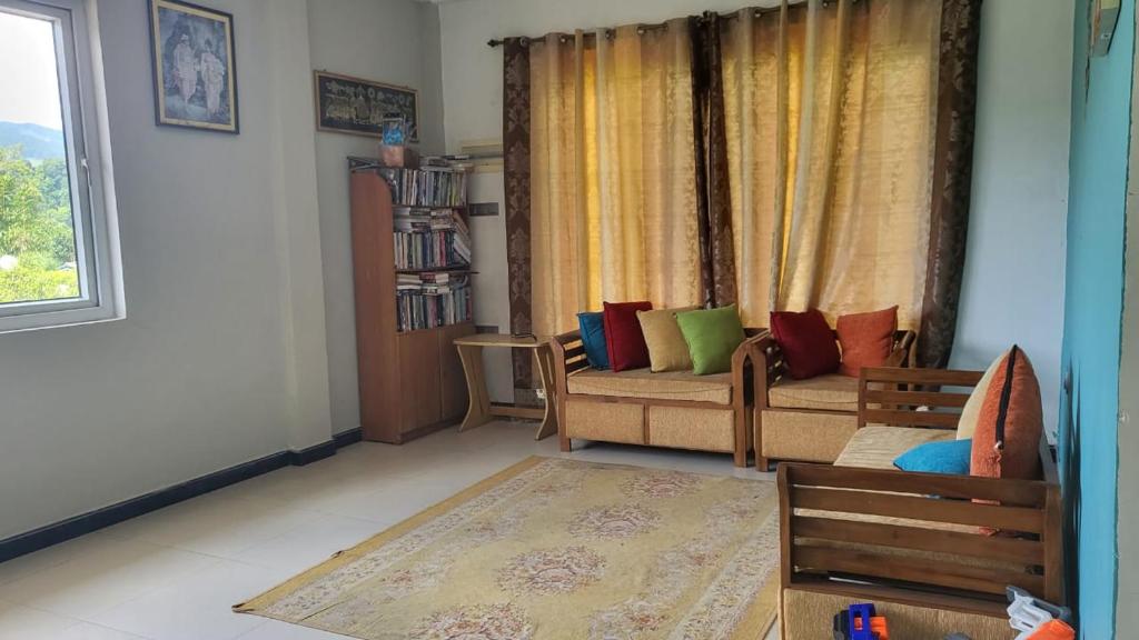 a living room with a couch and a window at Moon villa in Kandy