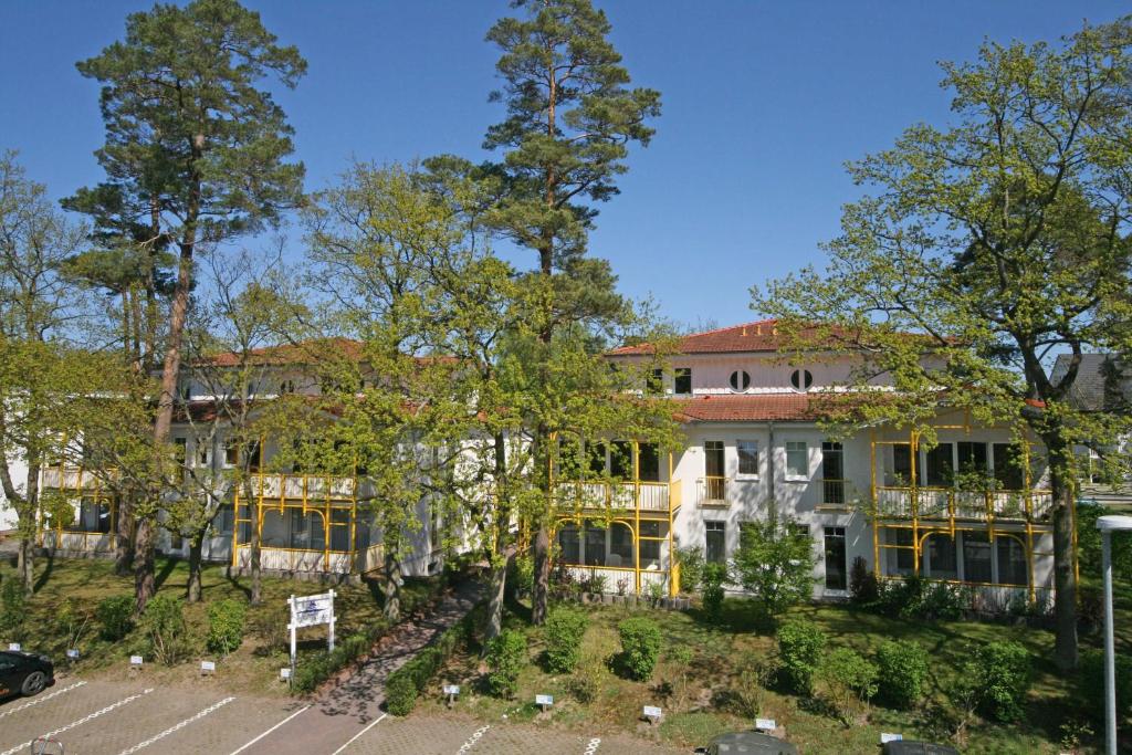 a large white building with trees in front of it at Villa Störtebeker - Whg 05 in Baabe