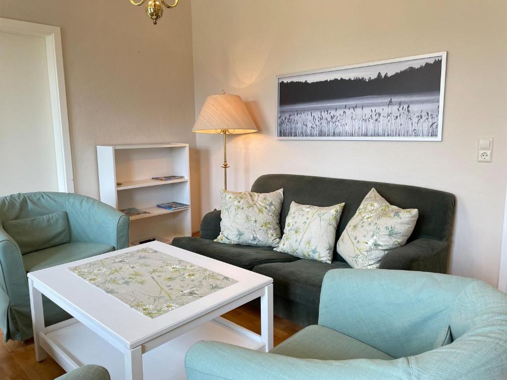 a living room with a couch and chairs and a table at Landgut in Vetschau