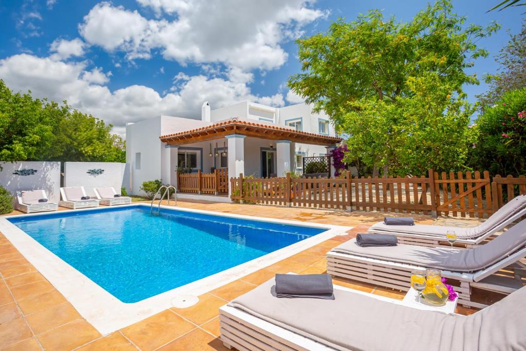 a villa with a swimming pool and a house at Casa Can Ferran in Nuestra Señora de Jesus