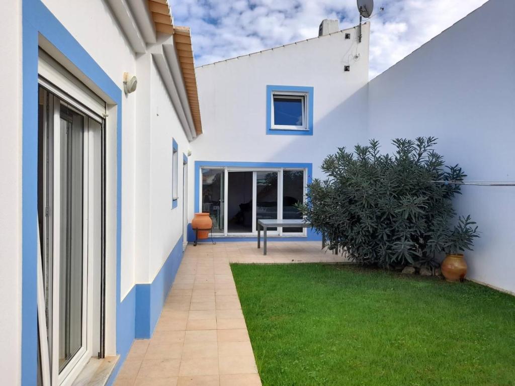 a blue and white house with a lawn at Le Vent Des Anges - The Wind of Angels in Sagres