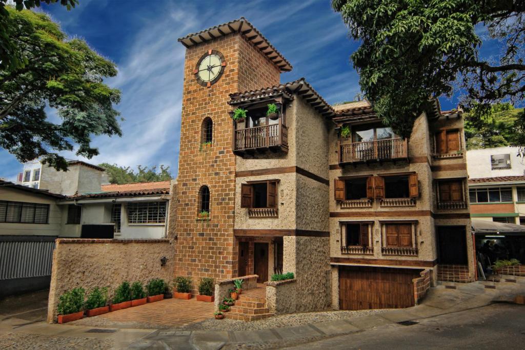 a large brick building with a clock tower at Casa Del Reloj in Medellín