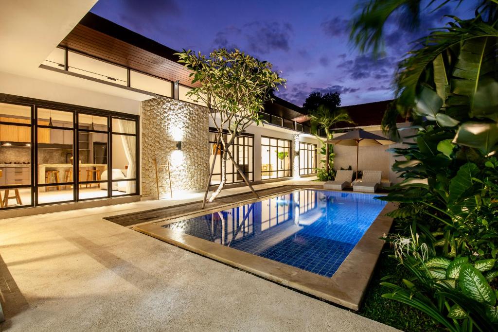 a swimming pool in the middle of a house at Billi Bali Villa in Canggu