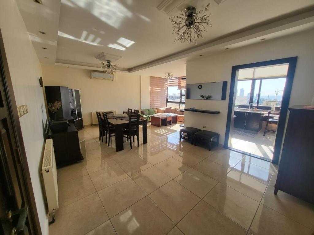 a kitchen and dining room with a table and chairs at Superb 2 Bed in middle of Amman in Amman