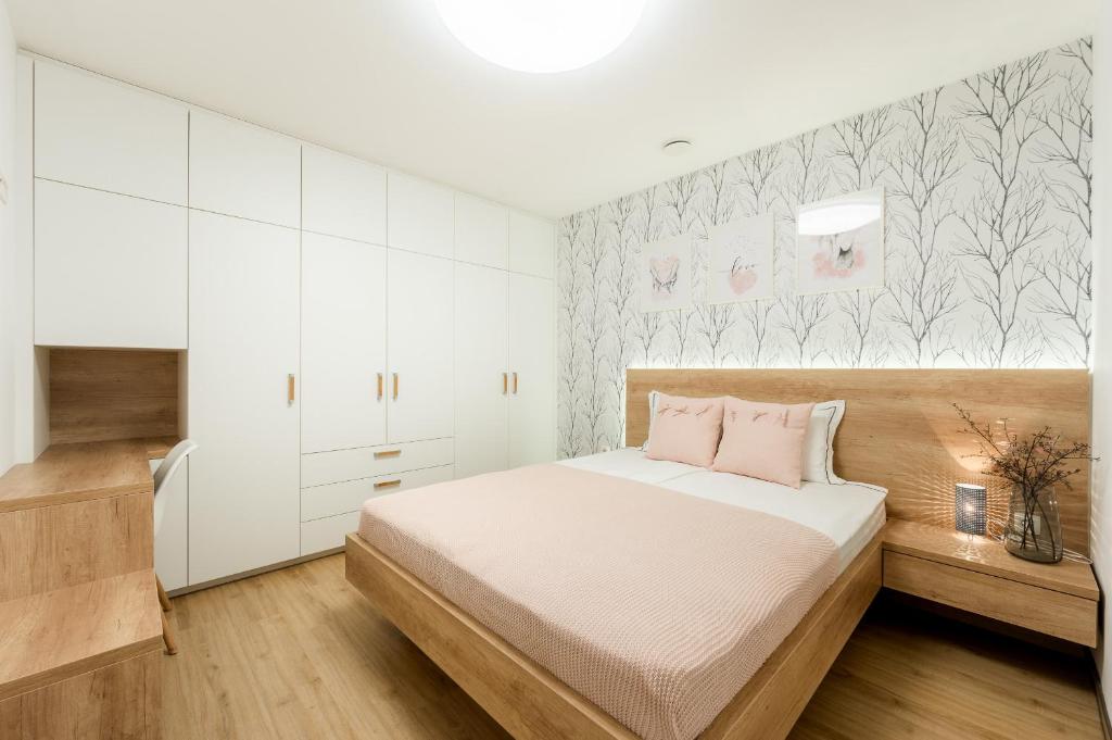 Postel nebo postele na pokoji v ubytování Apartments Gros