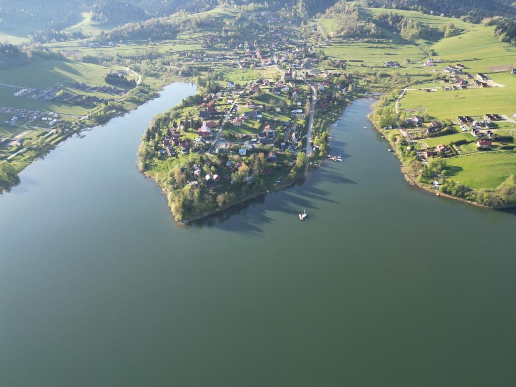 an aerial view of a small island in a river at Domki w Zawozie nad Soliną in Zawóz
